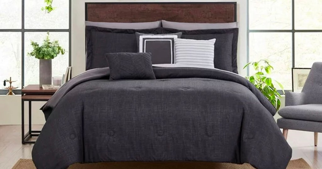 dark gray comforter set on bed in bedroom