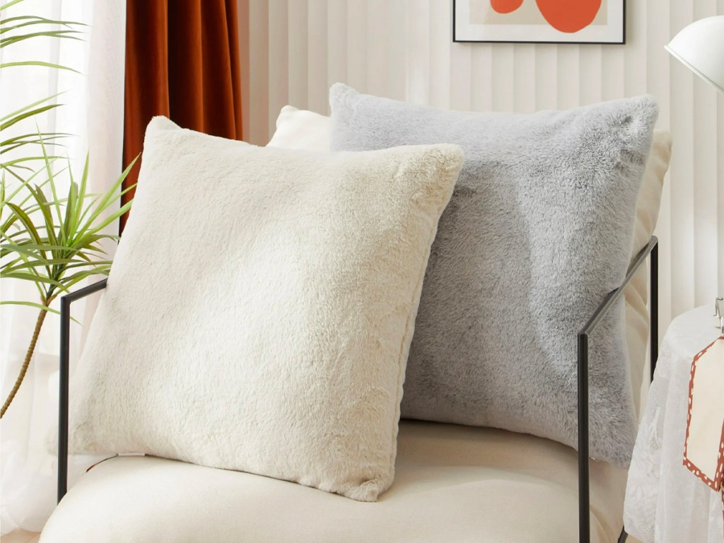 beige and gray fur pillows on chair