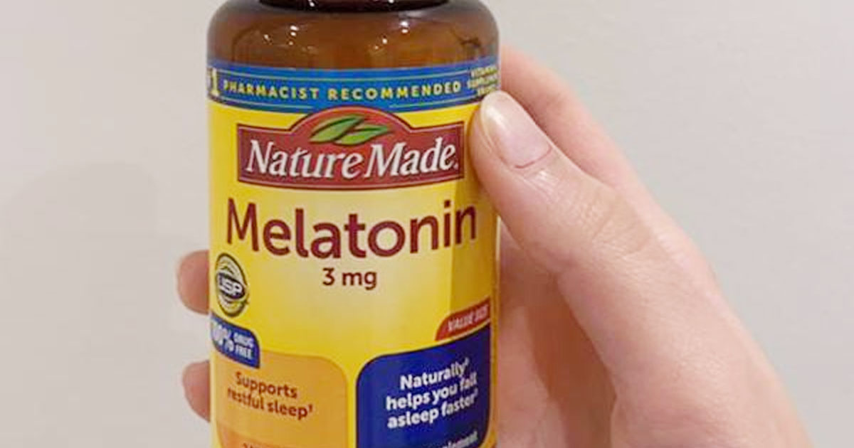 hand holding nature made melatonin vitamins
