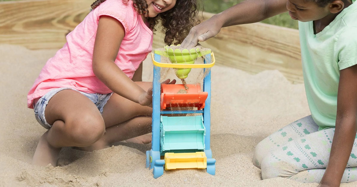 child playing with melissa and doug sand and water sifting funnel 