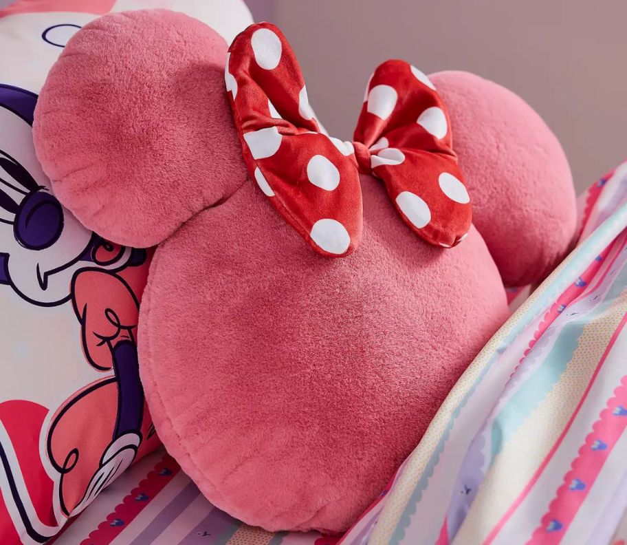 a pink squishy pillow shaped like minnie mouse's silhouette