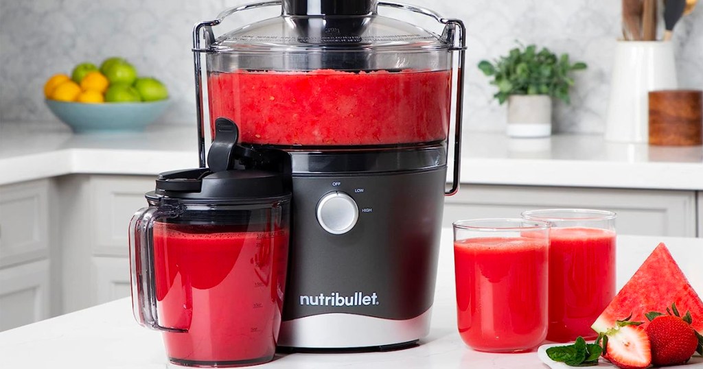 nutribullet juicer set full of watermelon juice on counter 