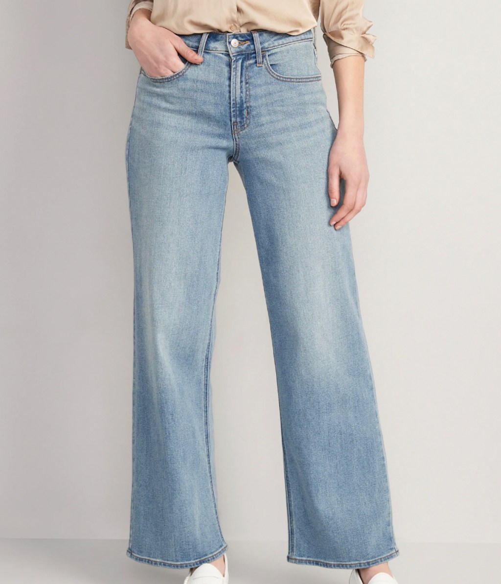 anthropologie clothes stock photo of model posing in medium wash wide leg denim jeans