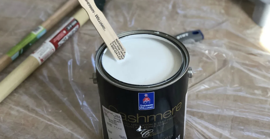 open paint can with wood paint stick