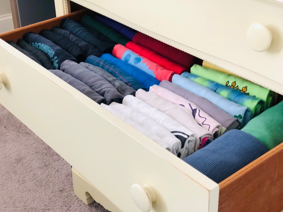 dresser with folded shirts