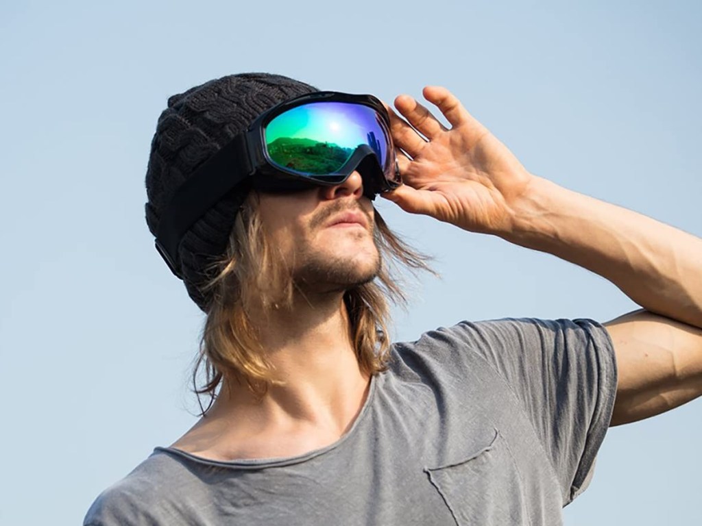 man wearing ski goggles over hat
