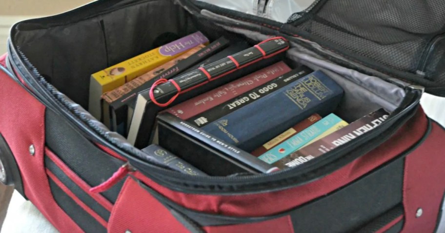 inside of red luggage with books inside for packing tips for moving with books