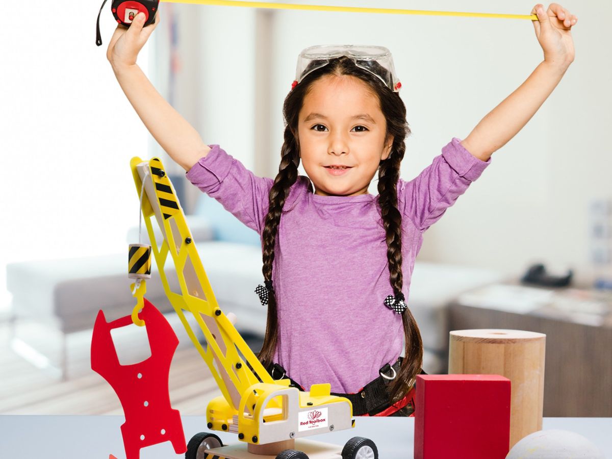 girl playing with construction building kit