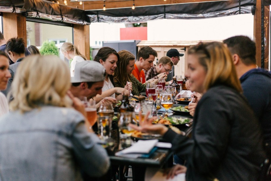 large group of people eating at restaurant