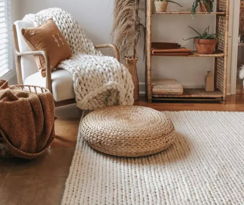 living room with braided rug with boho decor 