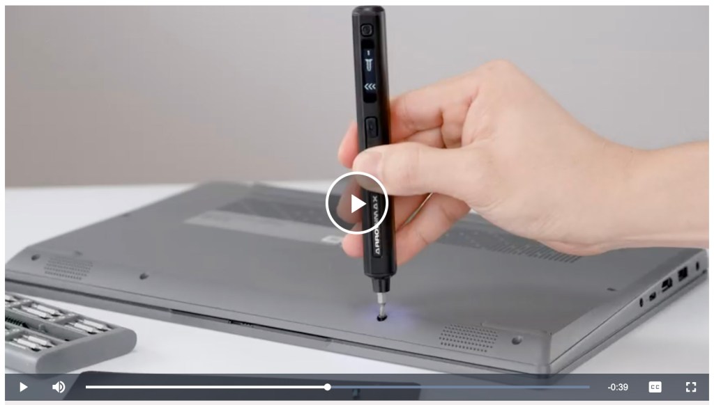 screenshot of video of person using screwdriver on back of laptop