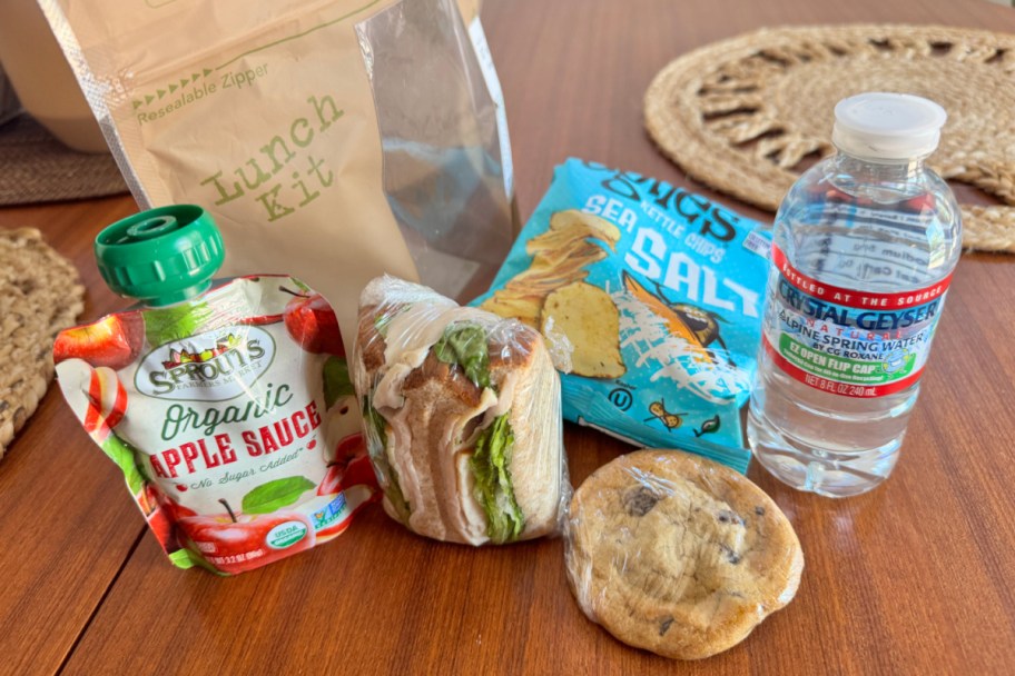 applesauce, sandwich, cookie, water, and bag of chips