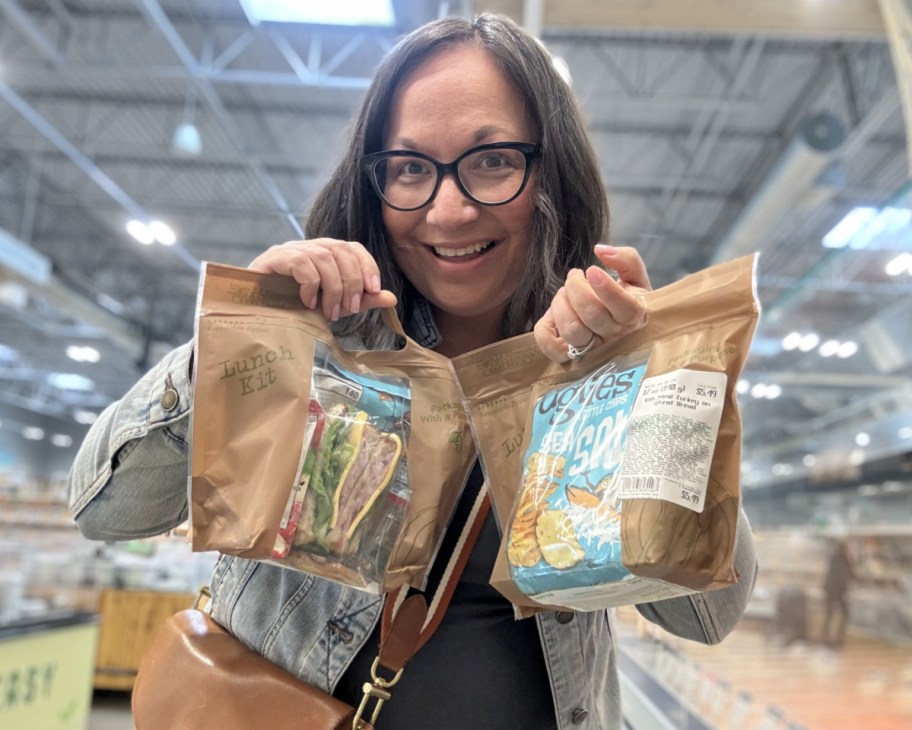 woman holding up bagged kids meals
