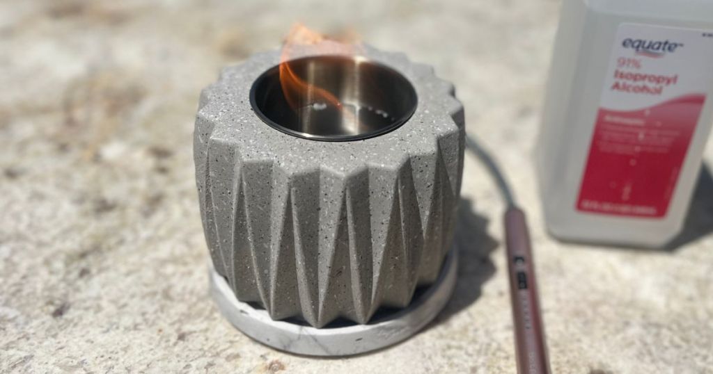 gray concrete portable mini fire pit on table with lighter and Rubbing Alcohol 