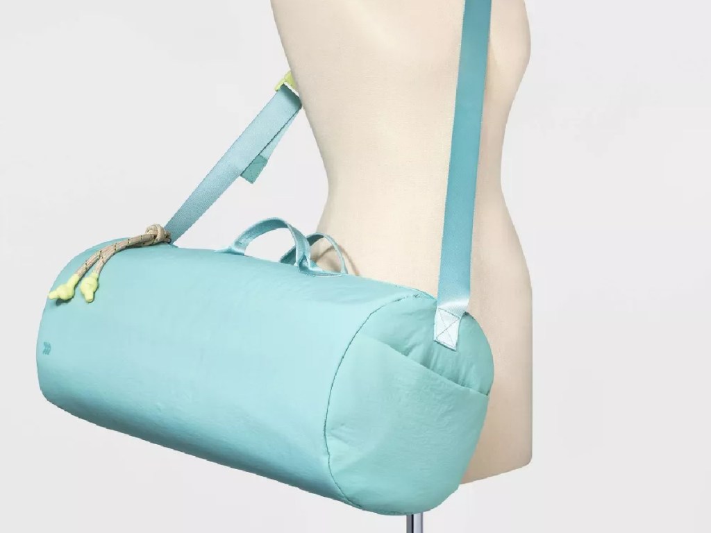 target all in motion teal duffel bag on a mannequin