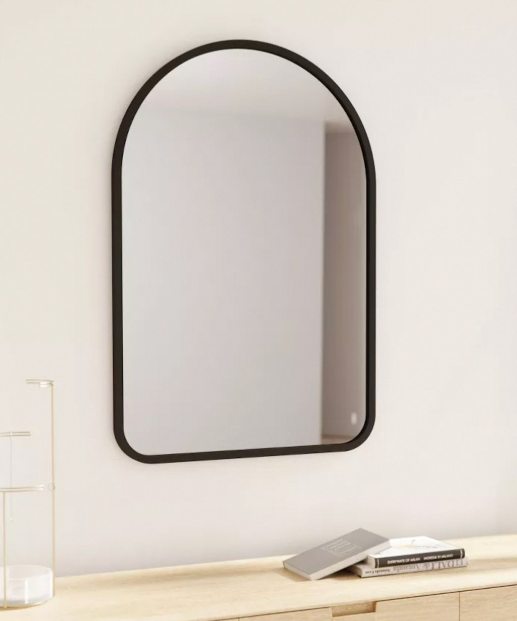 black arch mirror on white wall 