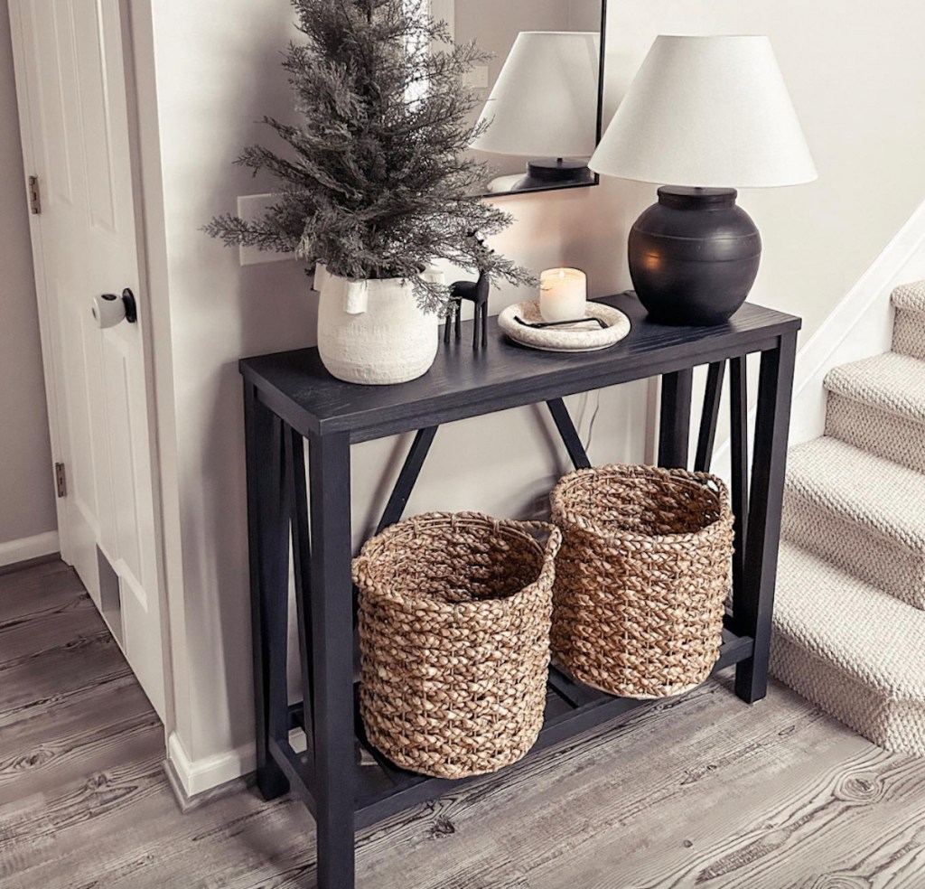 two woven baskets on black entryway table 