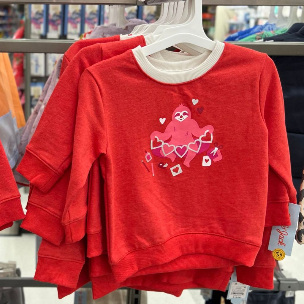 a red toddler shirt with monkey and hearts on the front. 