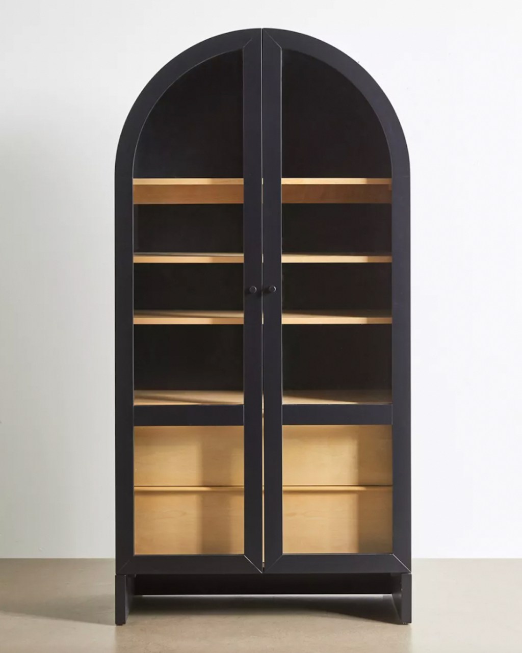 black and natural wood arch storage cabinet on floor 