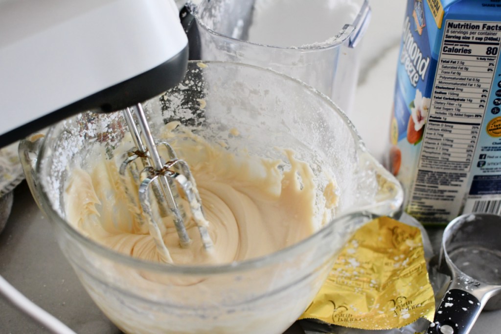 using a hand mixer to mix vegan frosting