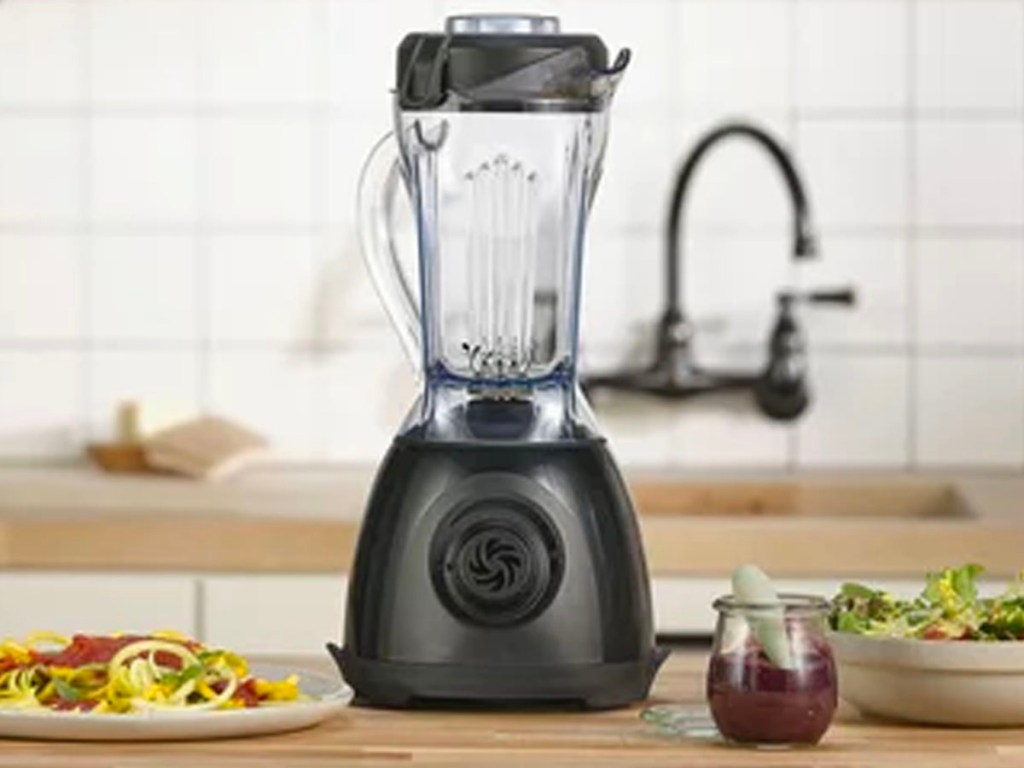 vitamix blender on kitchen counter with pasta and drink 