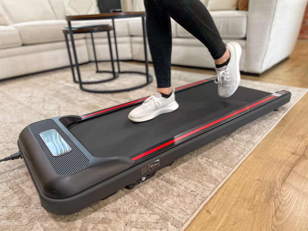 person walking on walking pad in living room
