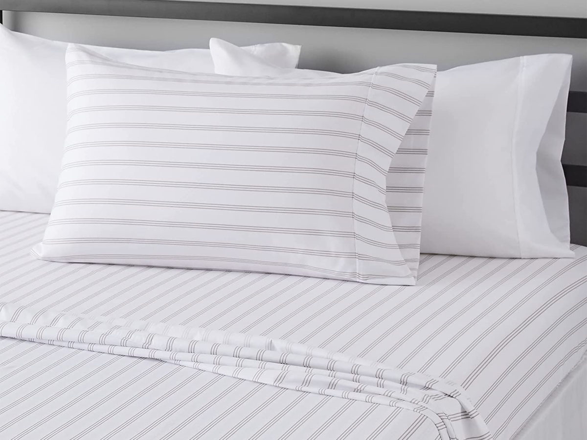 white striped sheet set on bed