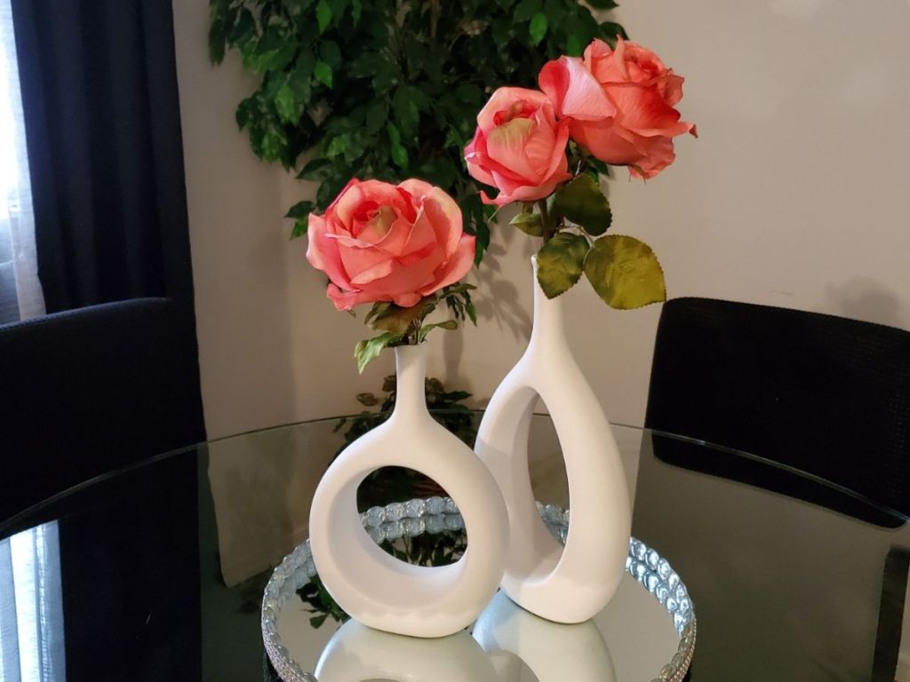 2 white vases with pink flowers