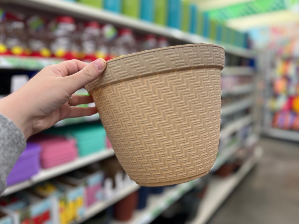woman holding Textured Faux Rattan Planters at the store
