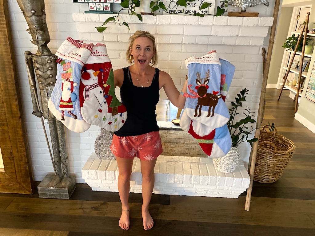 woman holding Pottery Barn stockings 