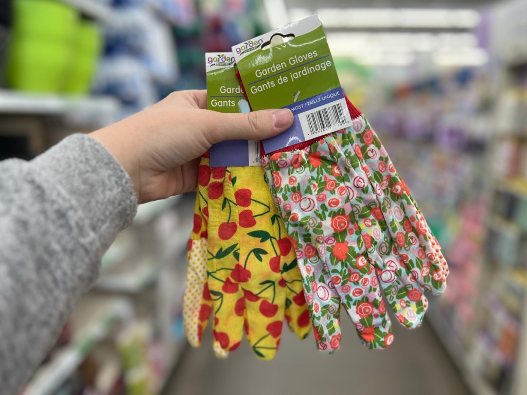 woman holding two Garden Collection Nitrile-Coated Fabric Garden Gloves at the store