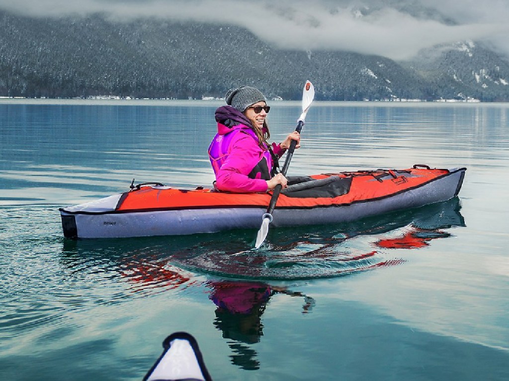Advanced Elements AdvancedFrame Inflatable Kayak in the middle of the ocean with woman on it