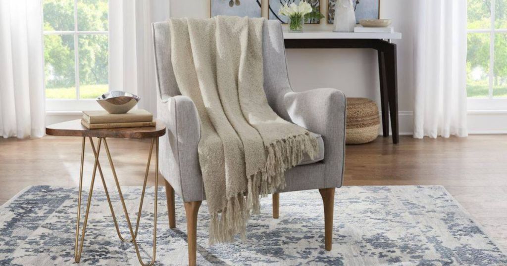 Home Decorators Collection Biscotti Ivory Cozy Boucle Throw Blanket with Tassels on a chair 