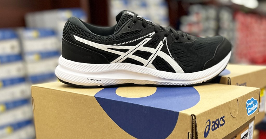 black and white asics shoe on top of shoe box