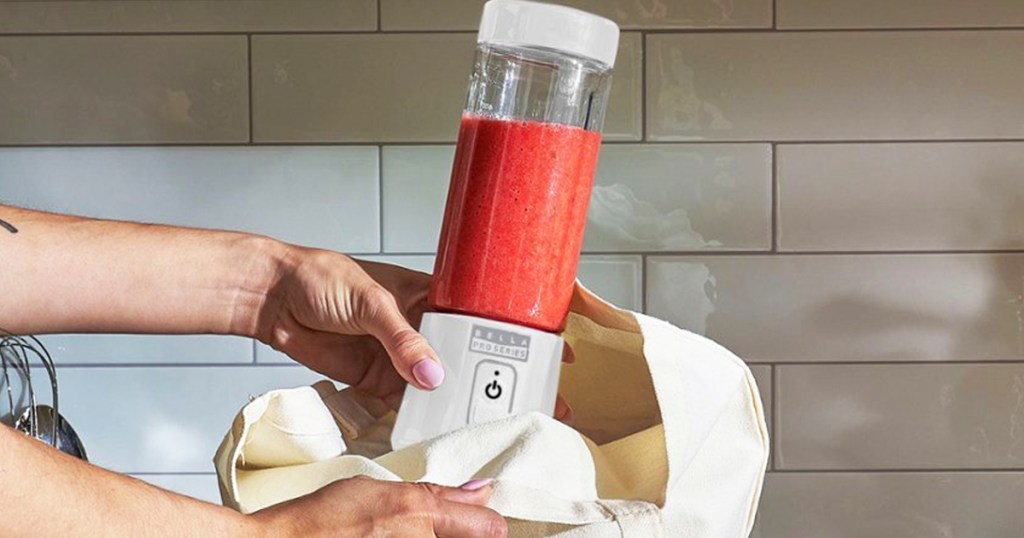 woman holding white personal blender