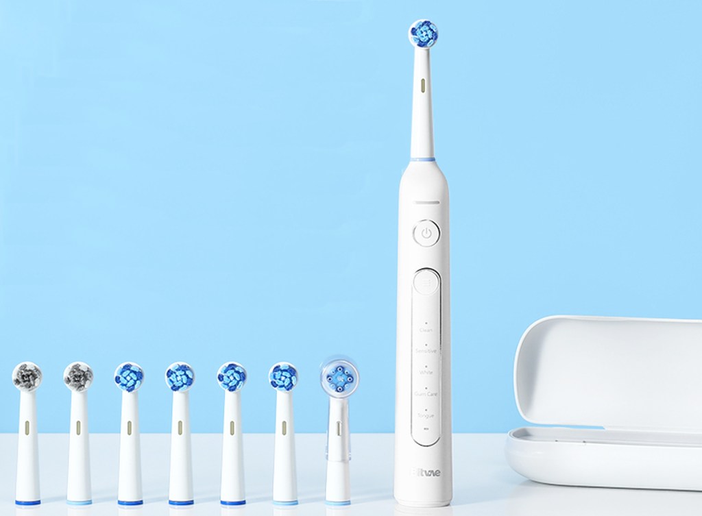 white electric toothbrush with brush heads and travel case