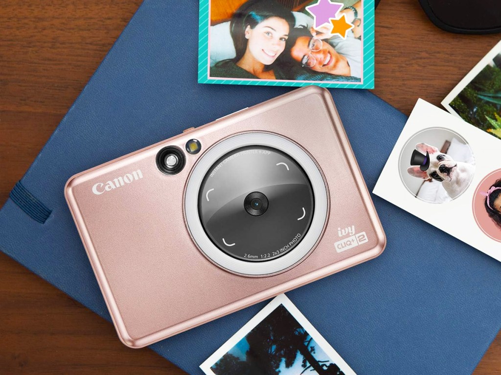 rose gold canon camera photo printer with mini prints around it