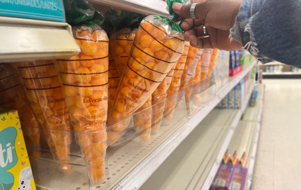 Woman holding a Carrot Cone filled with Cheese Balls 