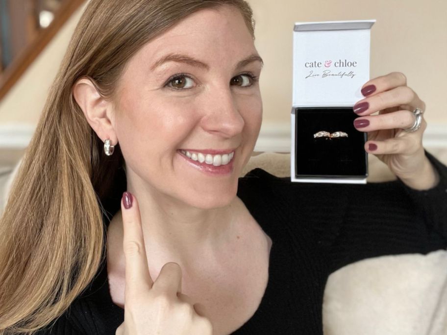 woman wearing Cate & Chloe Giselle silver Hoop Earrings and holding box with the same earrings in gold