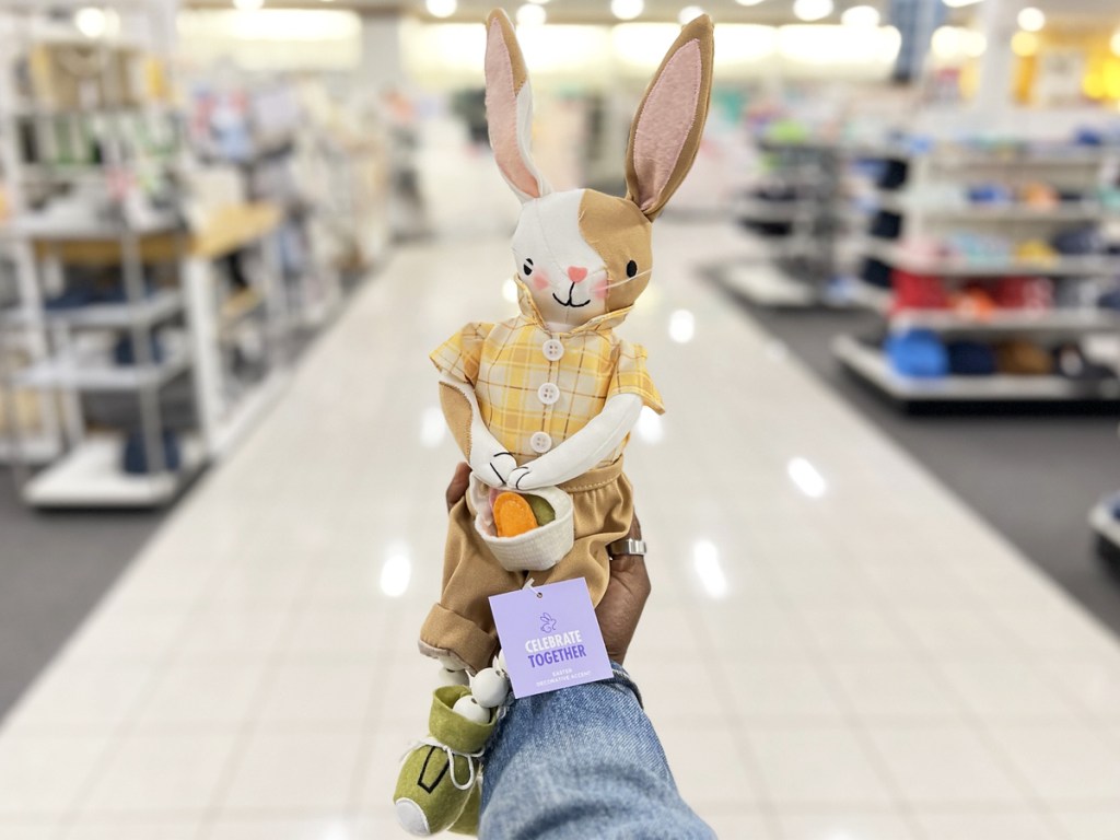hand holding up brown and white bunny decor