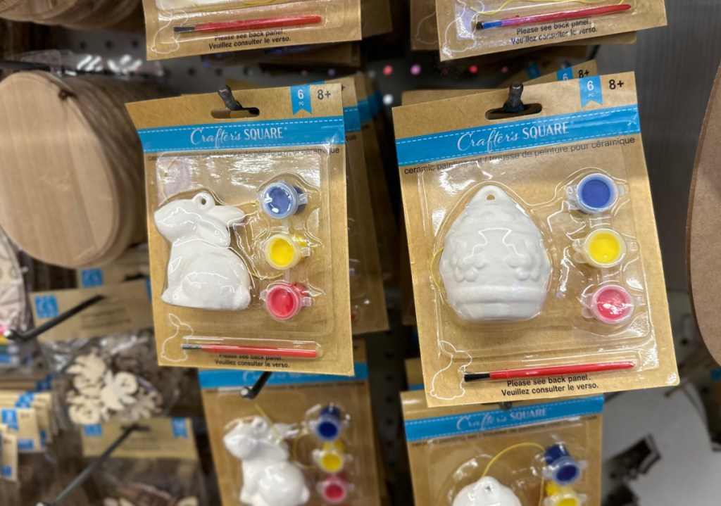 Ceramic Easter Paint Sets hanging from Dollar Tree hooks