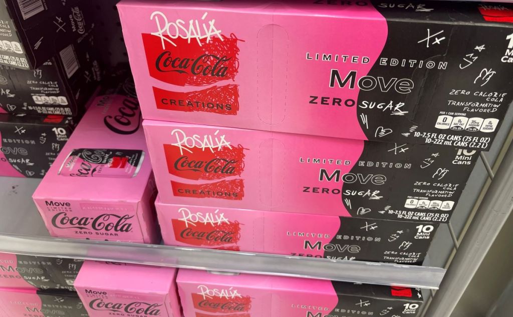 Stack of Coca-Cola Move Zero Sugar cases on a shelf at a store