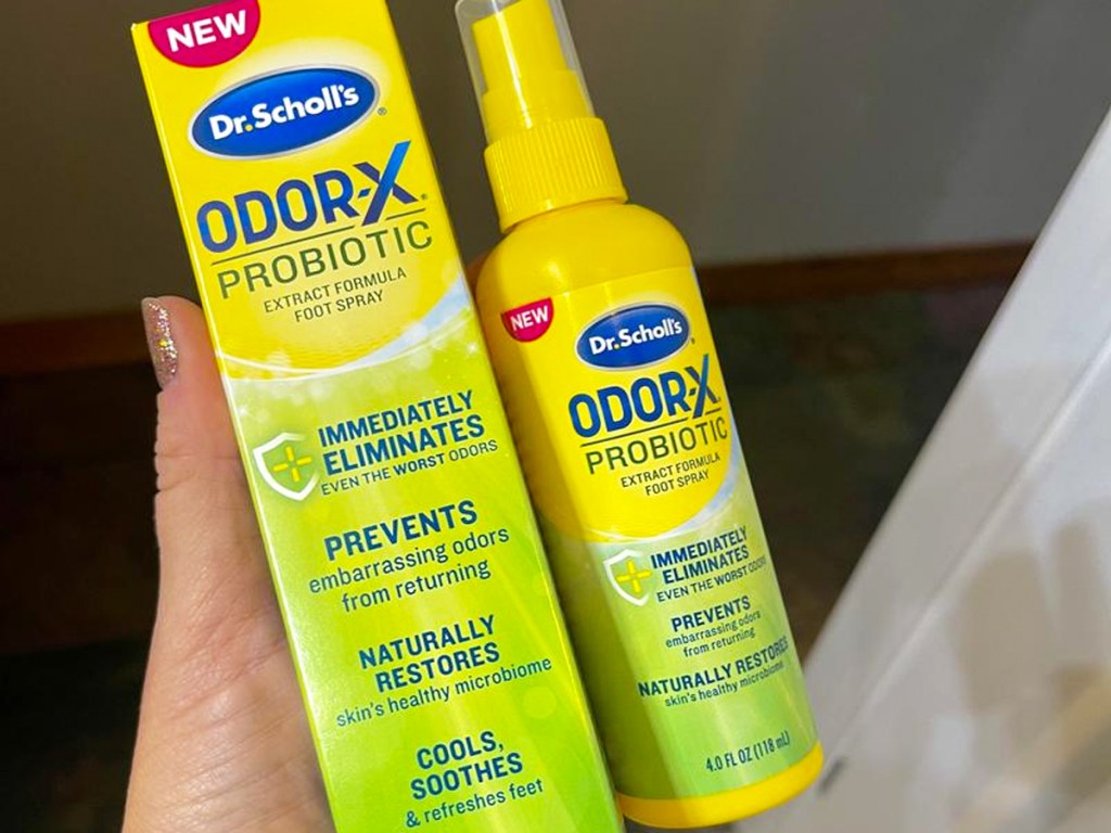 hand holding a bottle of Dr. Scholl's Probiotic Foot Spray