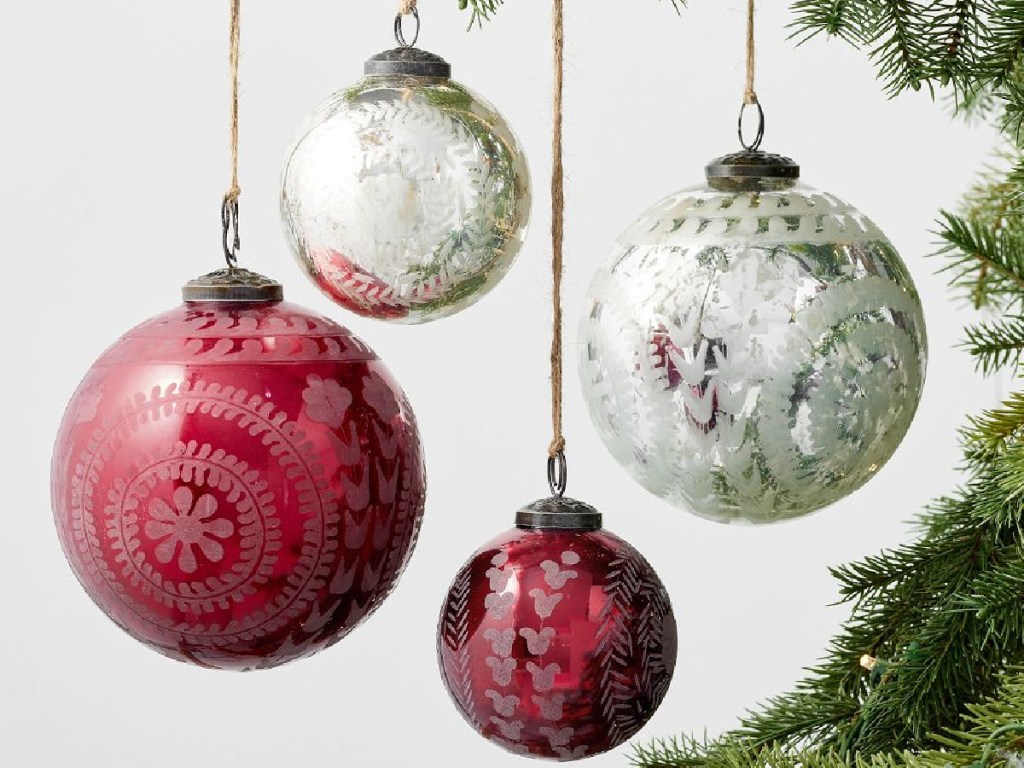 Etched Mercury Glass Ornaments in red and white on a tree in different sizes