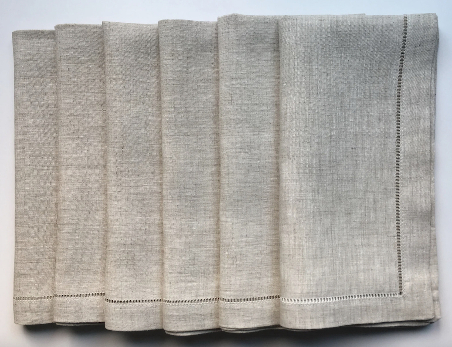 beige napkins with hemstitch laying in row