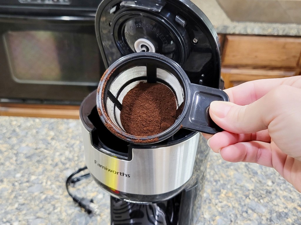 hand holding reusable filter in a single-serve coffee maker