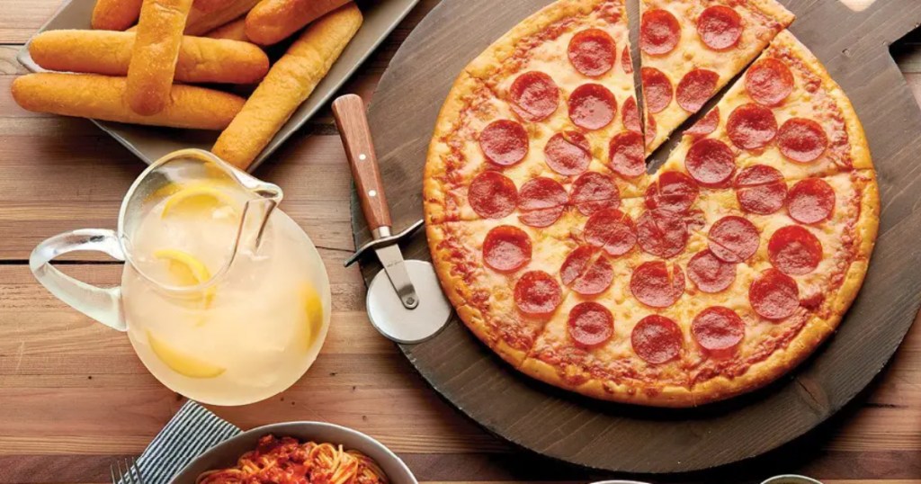 pizza, breadsticks, and a pitcher of lemonade