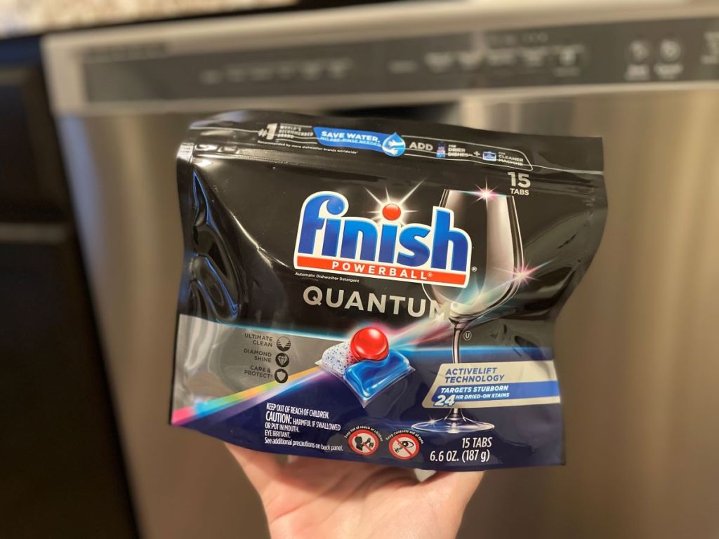 hand holding a bag of Finish Quantum Dishwasher Tabs