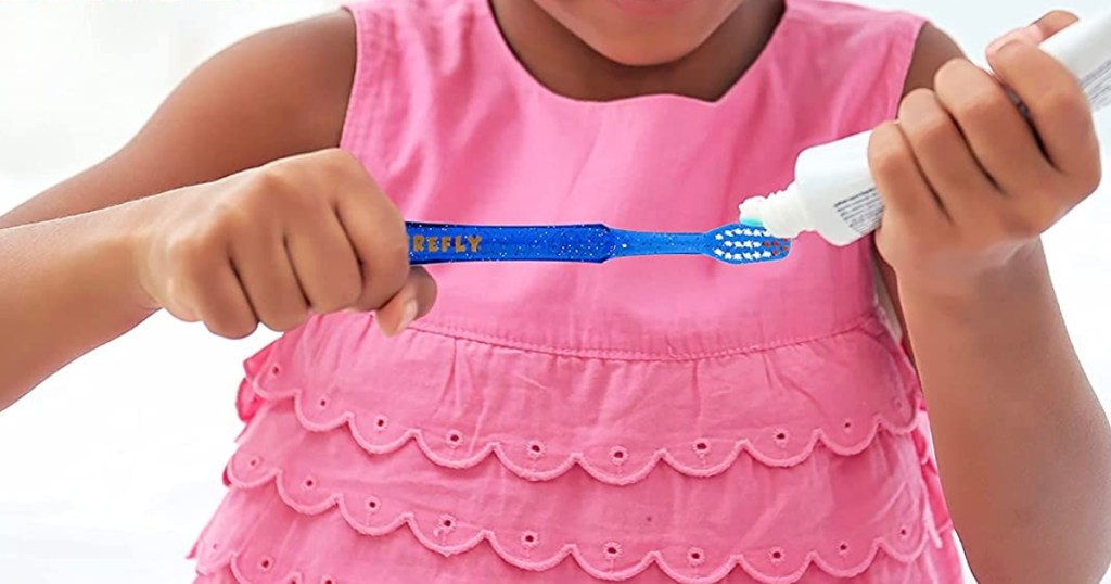 girl with Firefly Light-Up Timer Toothbrush
