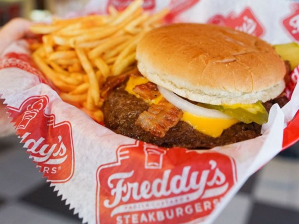 Freddy's Bacon and Cheese Steakburger in a basket with fries